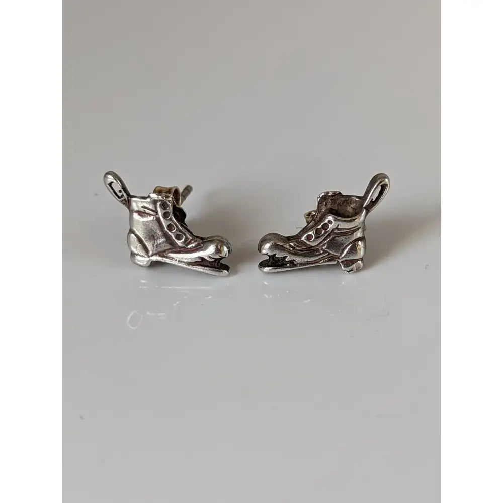 Silver steed broken boot stud earrings featuring silver ice skate-shaped stud earrings with detailed lacing and blade design