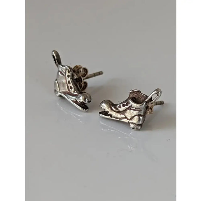 Silver steed broken boot stud earrings in silver shaped like roller skates with detailed lacing and toe caps
