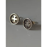 Silver steed button stud earrings in silver with a textured metallic finish and four-hole design stud earrings