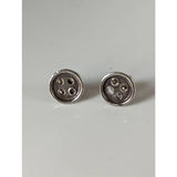 Silver steed button stud earrings showing silver button shaped stud earrings with four holes each