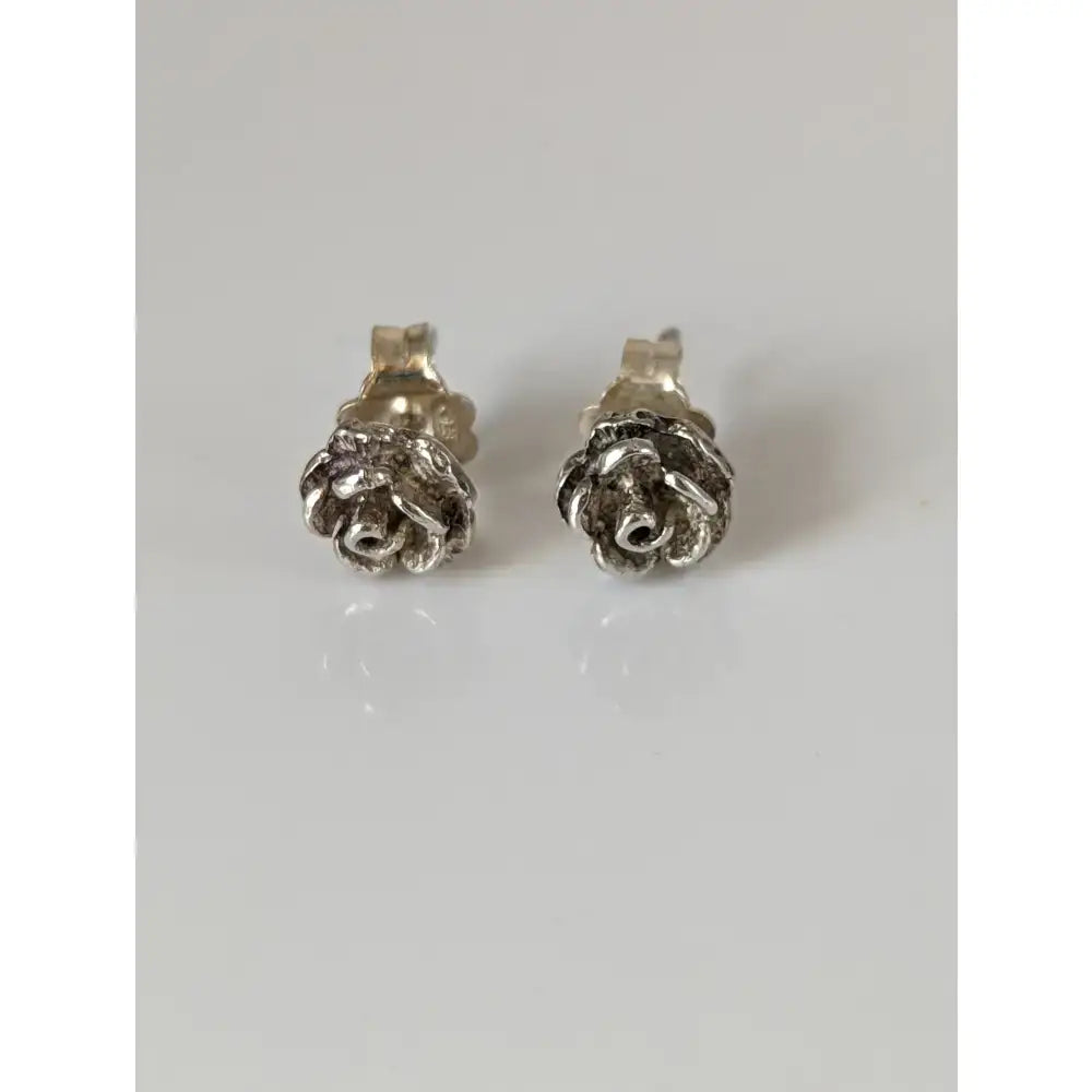 Silver steed carnation stud earrings with intricate textured petals and polished metallic silver finish
