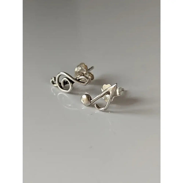 Silver steed celf silver note stud earrings with a polished metallic finish and minimalist celf note design
