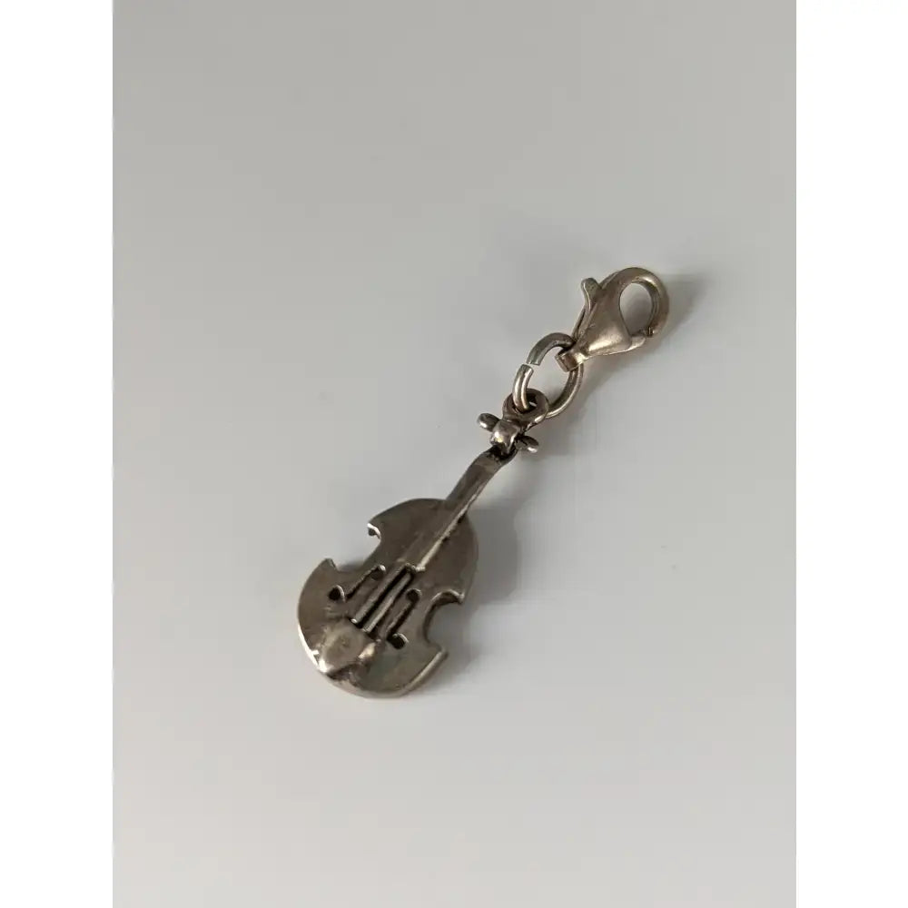 Silver steed cello silver charm shaped like a violin with a clasp made of shiny silver material