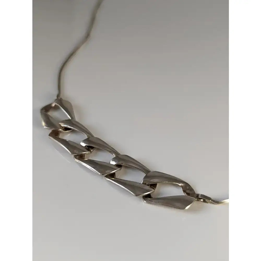 Silver steed chain link necklace with silver-toned geometric links in a modern angular chain link necklace design