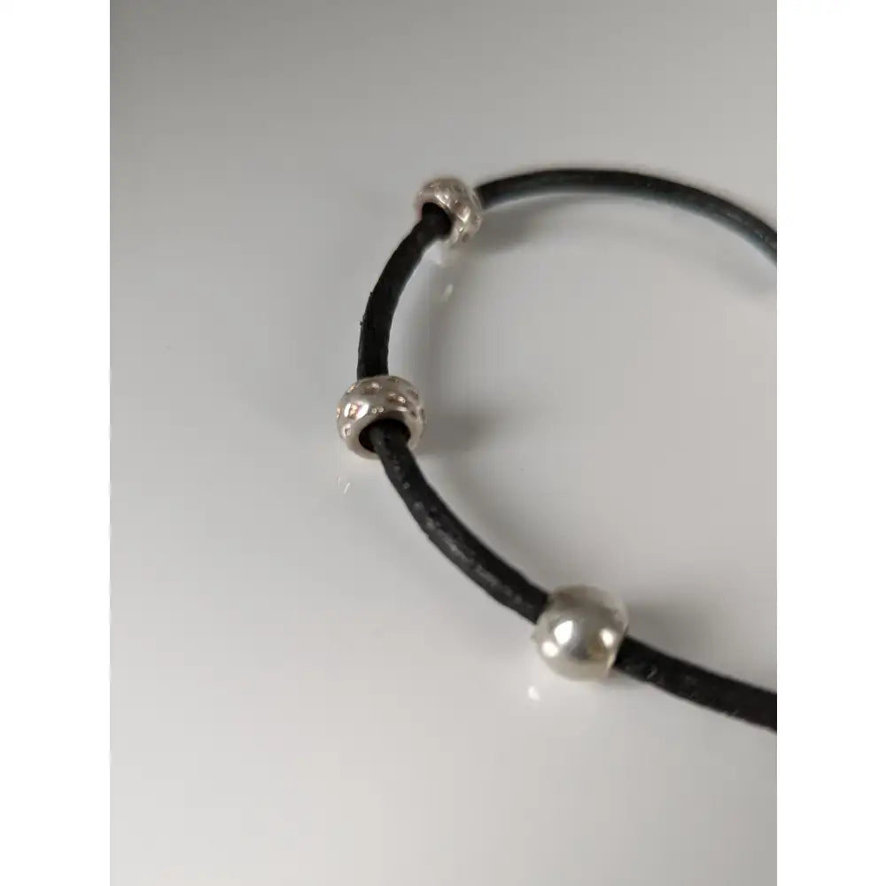 Black leather cord bracelet with silver steed charms and silver-toned spherical beads on 26cm leather cord