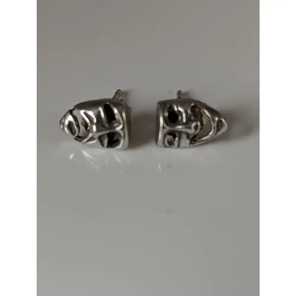 Silver steed skull shaped stud earrings with intricate engraved details perfect as steed comedy tragedy masks stud earrings