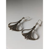 Silver steed crest dropped earrings featuring silver teardrop shape with hammered texture and bead clusters at bottom