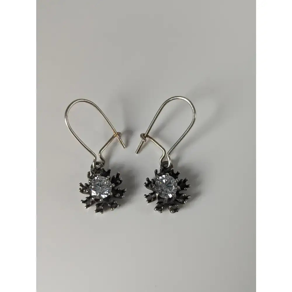Silver steed crystal sunflower dropped earrings with handmade silver snowflake design and blackened metal petals