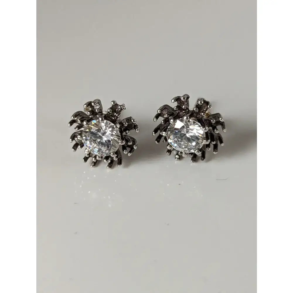 Silver steed crystal sunflower stud earrings shaped like spiders with clear crystals on silver legs