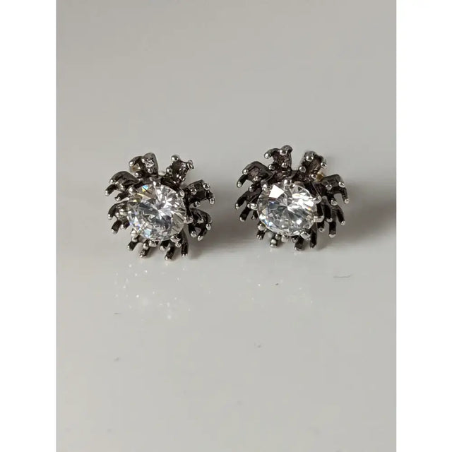 Silver steed crystal sunflower stud earrings shaped like spiders with clear crystals on silver legs