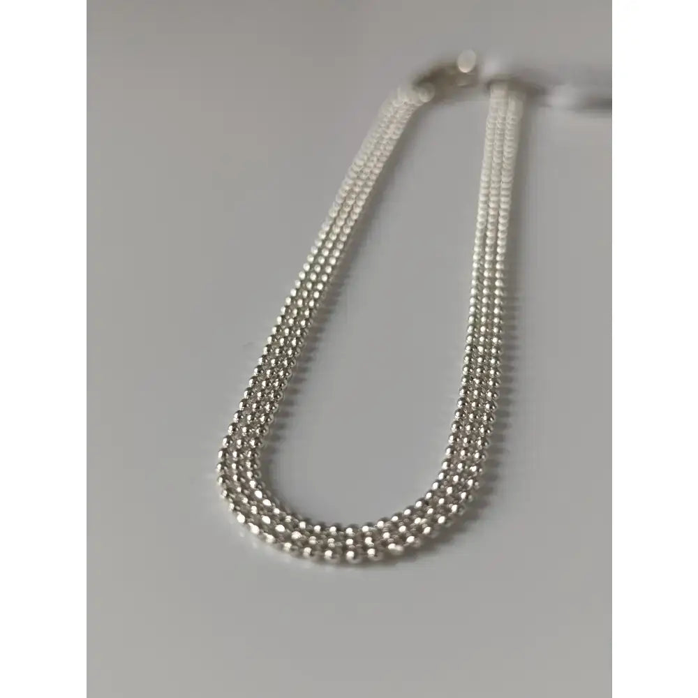 Silver steed curtain silver bracelet with silver-toned multi-strand beaded chain and sleek interlocking design