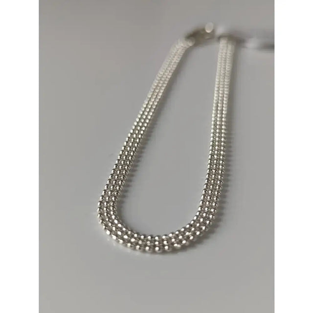 Silver steed curtain silver bracelet with silver-toned multi-strand beaded chain and sleek interlocking design