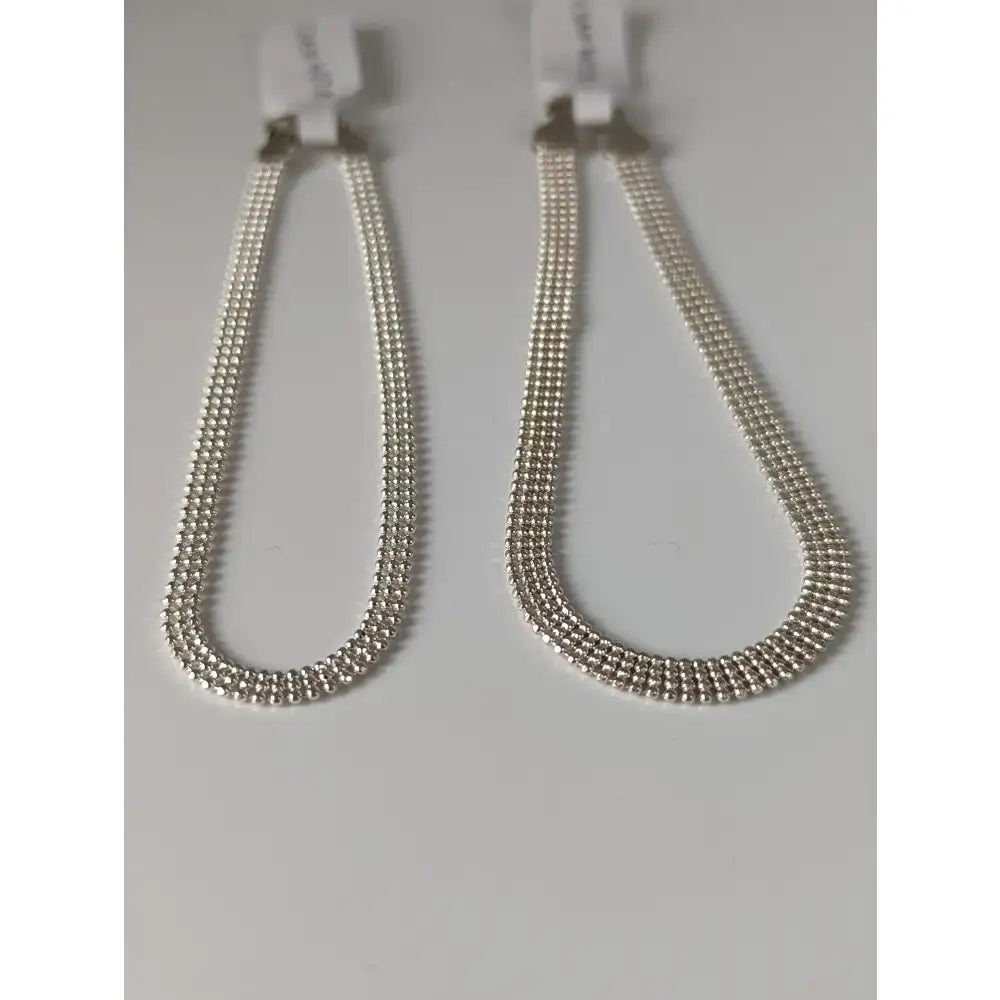 Silver steed curtain silver bracelet with sleek silver multi-strand beads and white plastic clasp phone strap