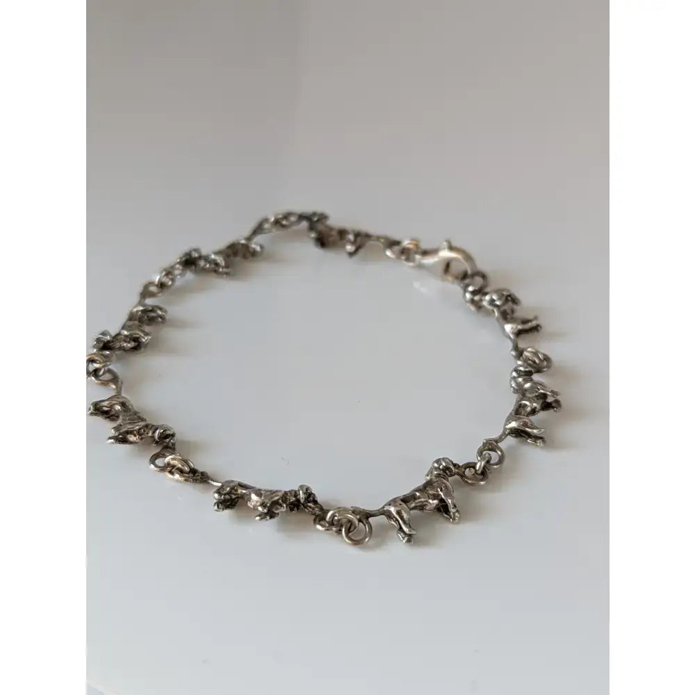 Silver steed dachshund silver bracelet featuring a silver chain with small detailed elephant figurines design