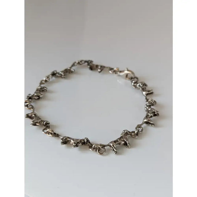 Silver steed dachshund silver bracelet featuring a silver chain with small detailed elephant figurines design
