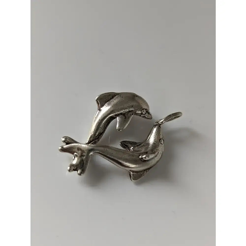 Silver steed dancing dolphins silver pendant featuring two polished metal dolphins leaping in a dynamic pose