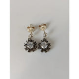 Silver steed dangling crystal sunflower stud earrings with clear central gemstone and dark spiky metal petals