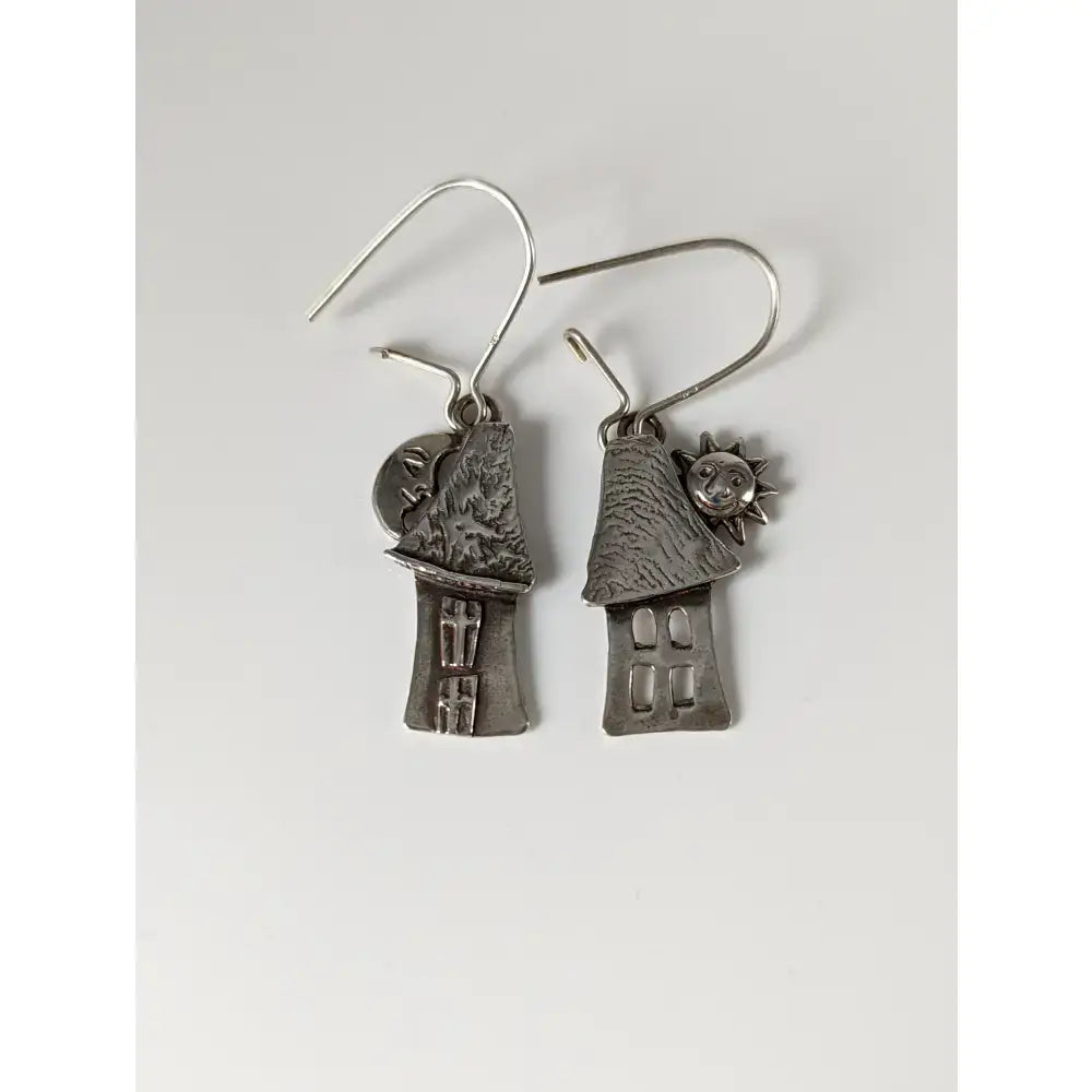 Silver steed day and night house dropped earrings feature silver-toned house shapes with textured roofs and sun and moon charms
