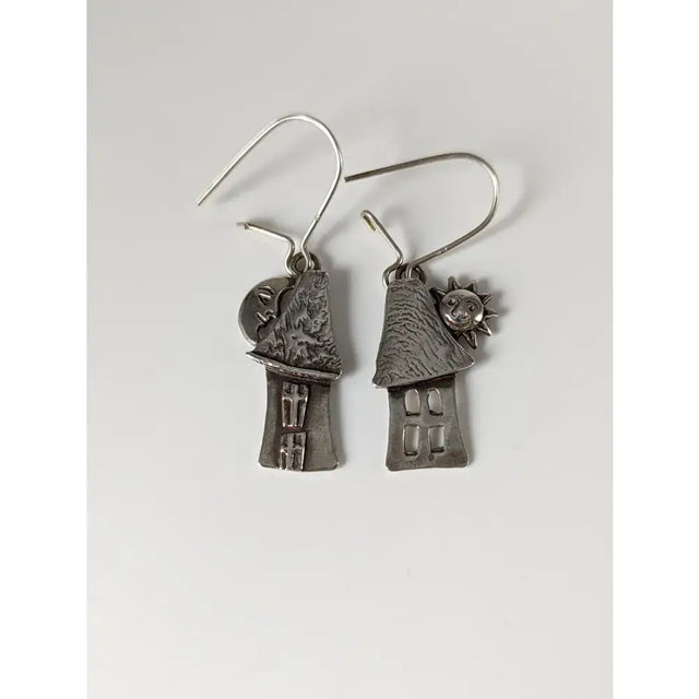 Silver steed day and night house dropped earrings feature silver-toned house shapes with textured roofs and sun and moon charms