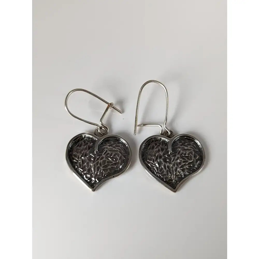 Silver steed detailed heart dropped earrings featuring intricate textured silver heart-shaped design