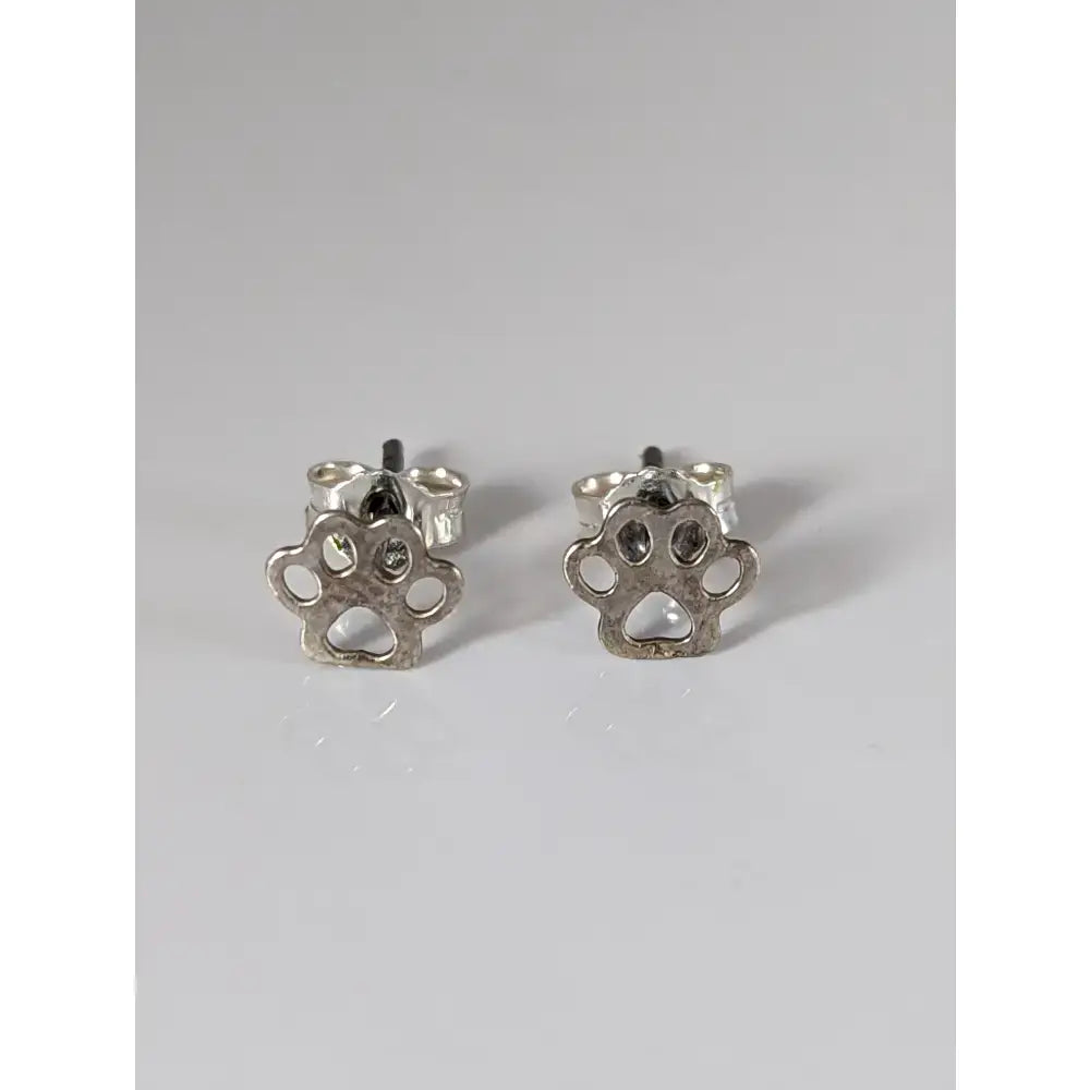 Silver steed silver sterling silver dog paws stud earrings with minimalist cut out design in silver color