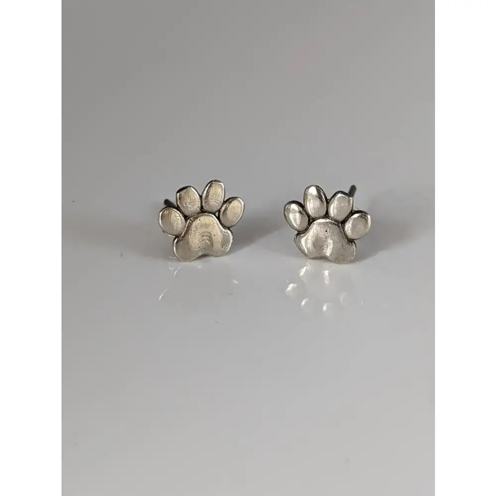Silver steed sterling silver dog paws stud earrings with rustic textured finish in silver paw print design