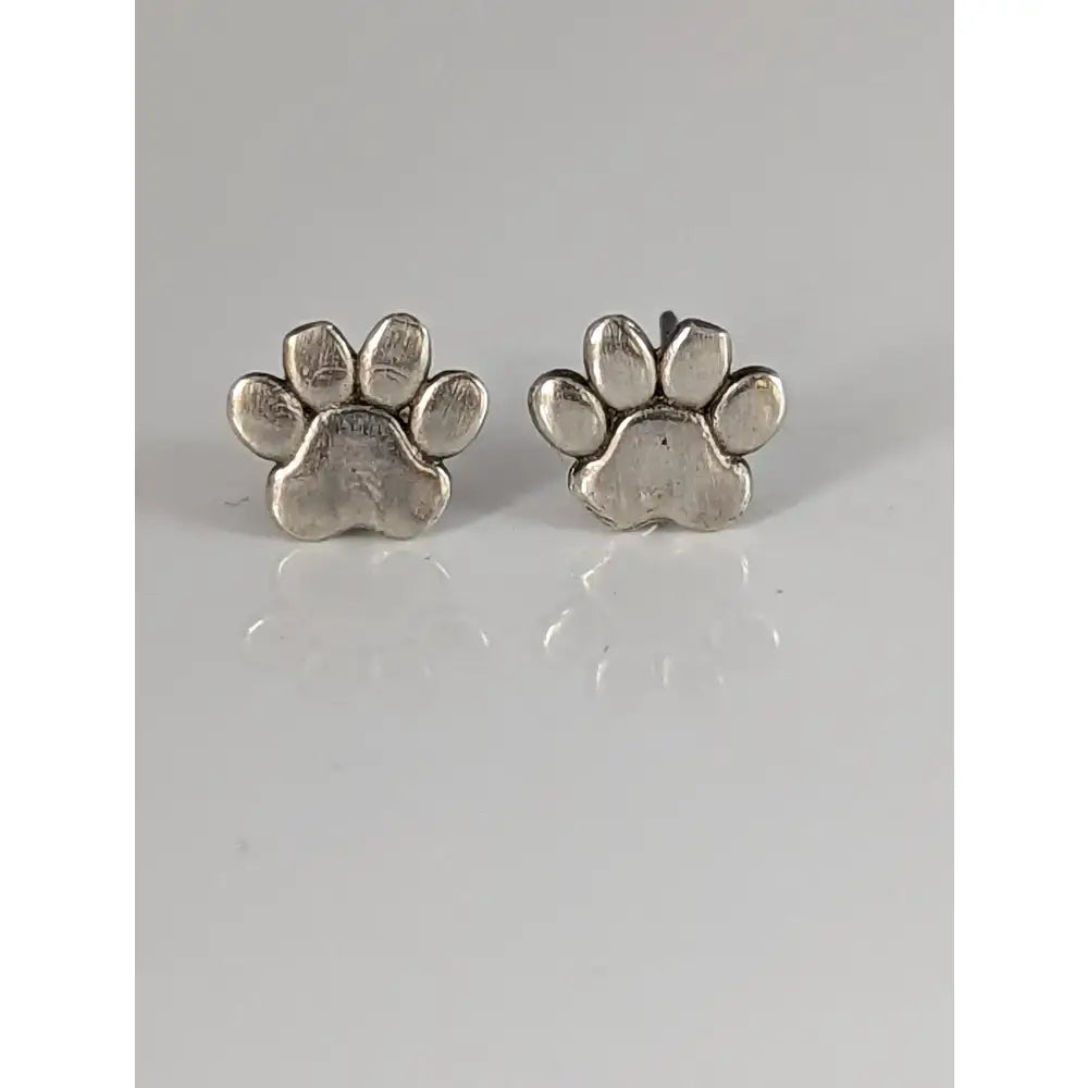 Silver steed sterling silver stud earrings with textured silver dog paws design and metallic finish