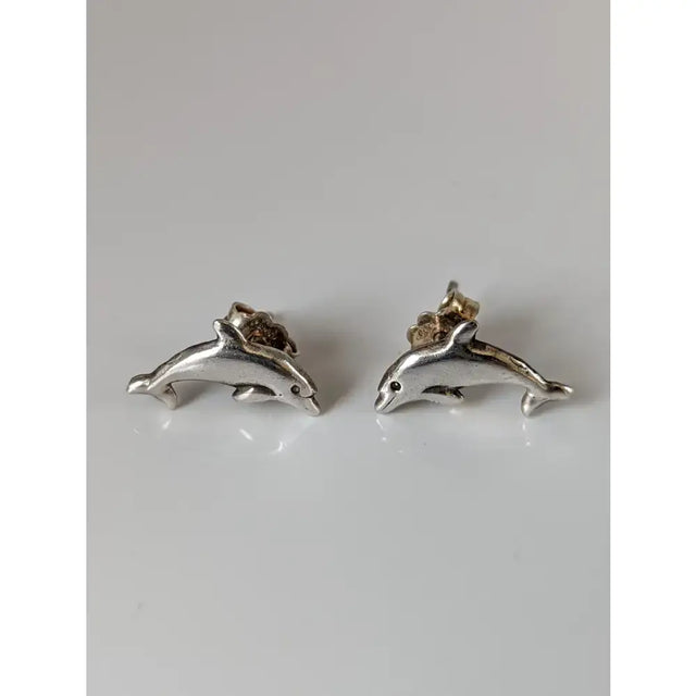 Silver steed dolphin stud earrings with polished metallic finish and detailed silver dolphin design