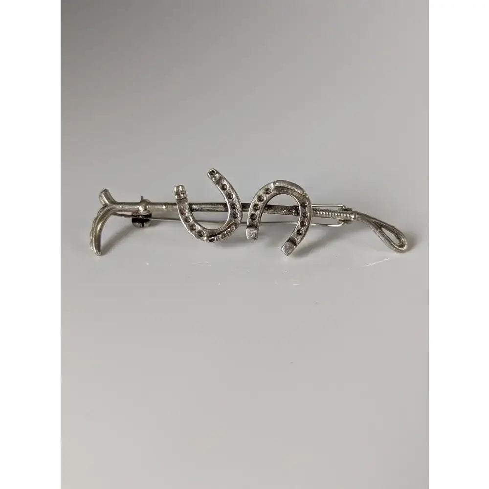 Silver steed double shoe silver brooch with two horseshoe designs and dark stones stock tie pin
