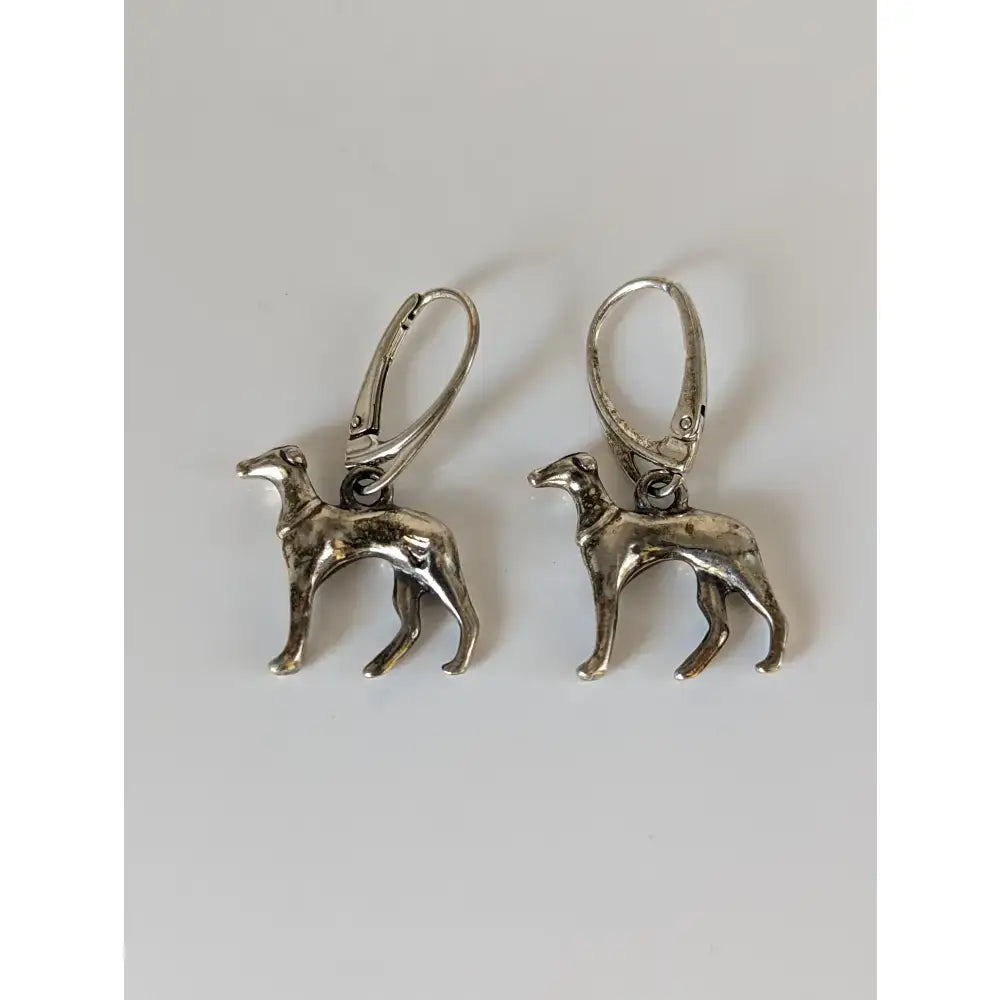 Silver steed dropped greyhound earrings are silver dog-shaped dropped greyhound earrings with intricate details and lever-back closures
