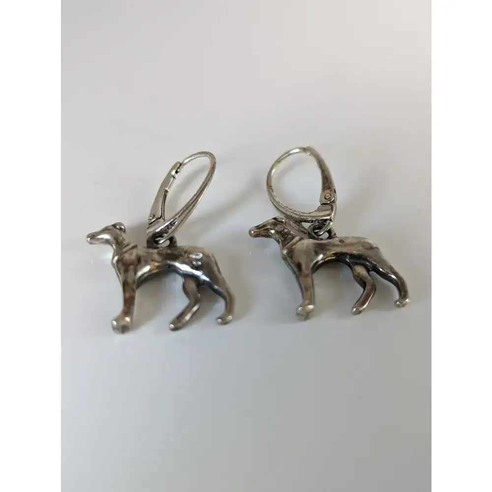 Silver steed dropped greyhound earrings featuring silver dog-shaped dropped greyhound earrings with lever-back closures