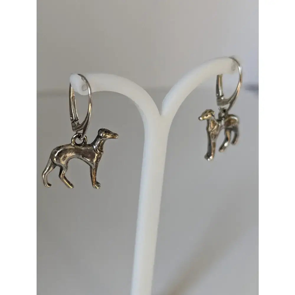 Silver steed dropped greyhound earrings are silver-colored dangle earrings with intricate detailing and a polished finish