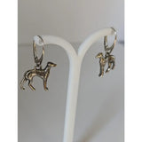 Silver steed dropped greyhound earrings are silver-colored dangle earrings with intricate detailing and a polished finish