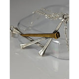 Silver steed elegant hoof nails necklace featuring a silver and gold rustic cross-shaped nail pendant