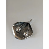 Silver steed extravagant leaf and stems silver pendant with a silver leaf and two polished cherry spheres on a stem