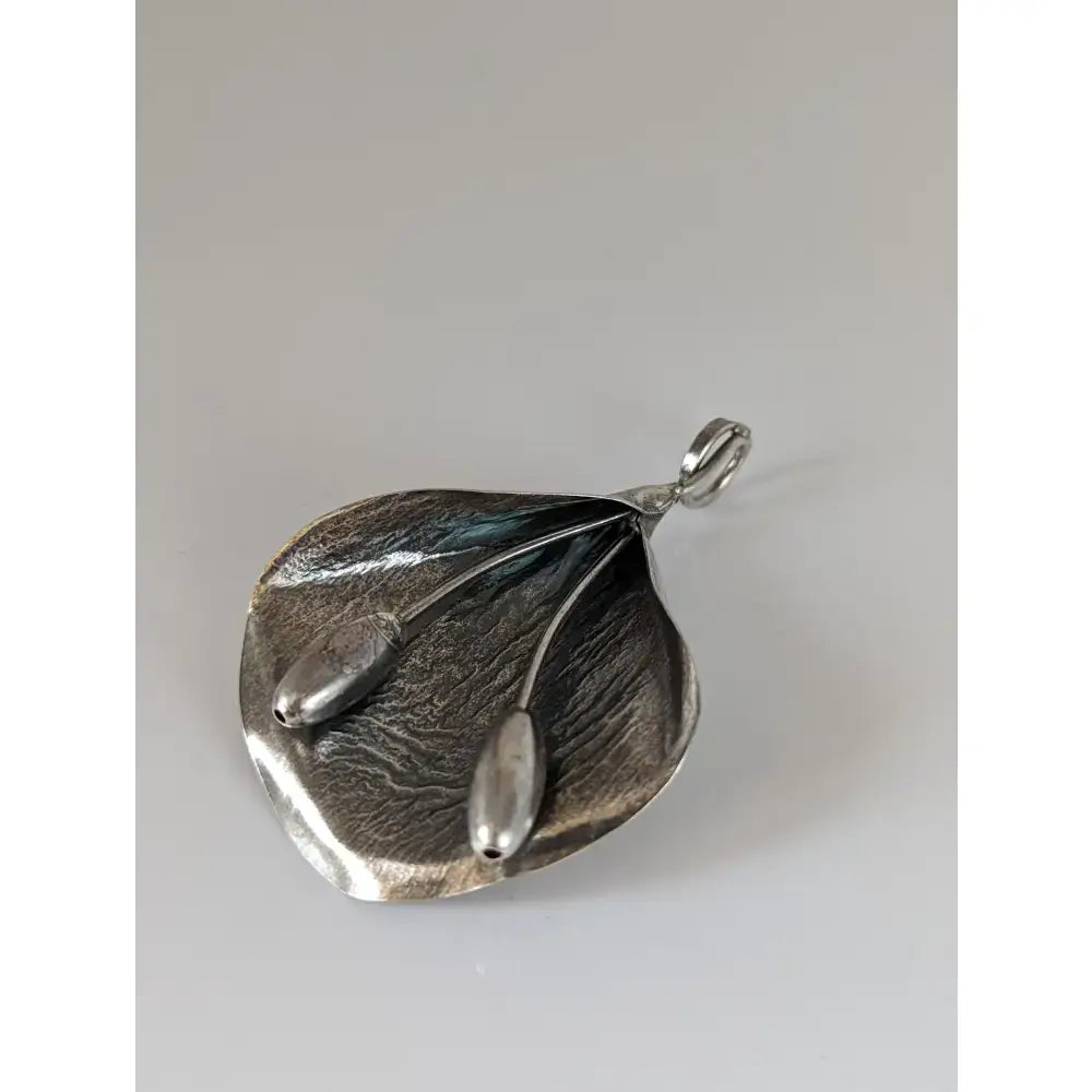 Silver steed extravagant silver pendant featuring a leaf shape with stems design and two small oval metal beads