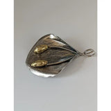 Silver steed extravagant silver pendant shaped like a textured leaf with gold-colored seed pods on slender stems