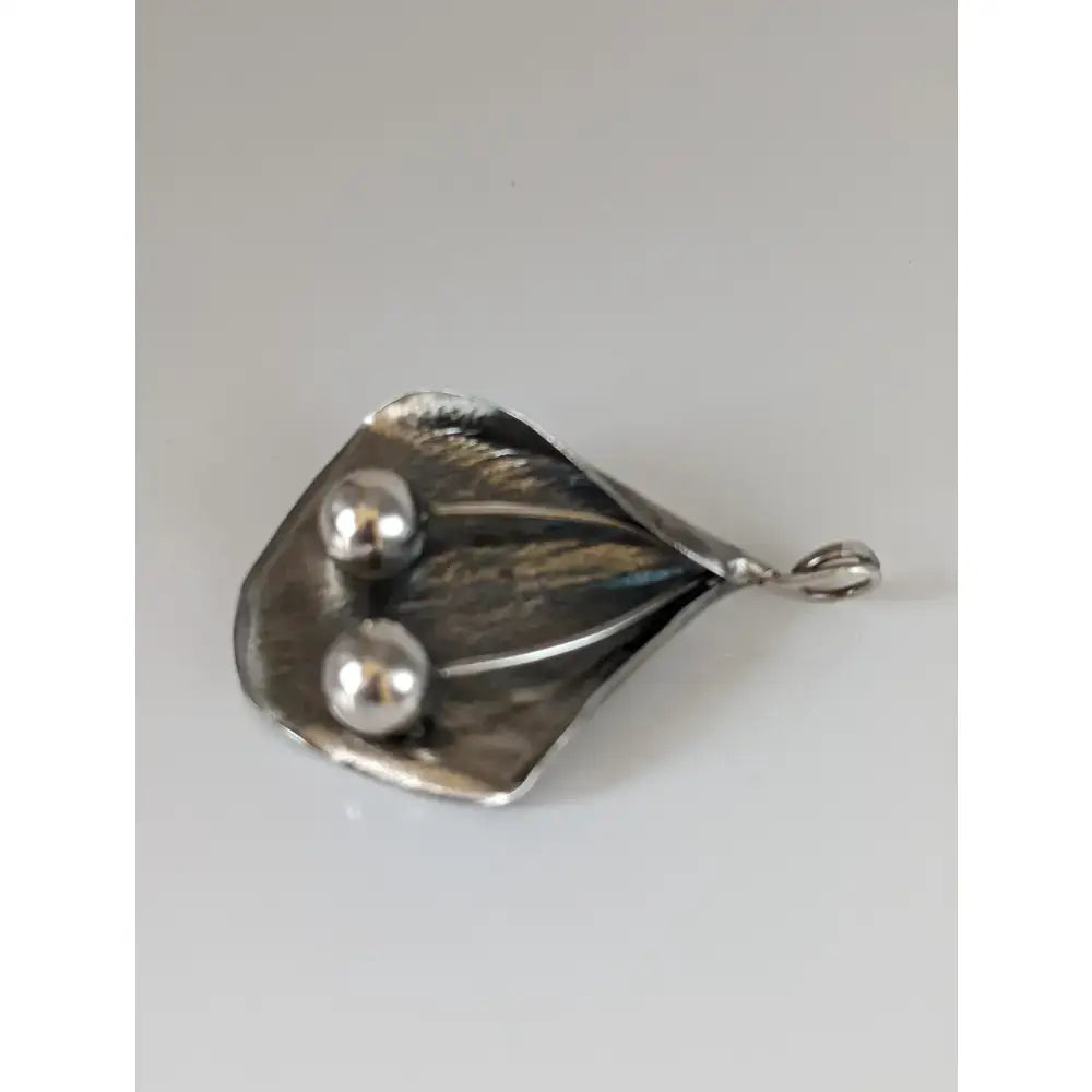 Silver steed extravagant silver pendant with leaf shape, two polished silver spheres, and small attachment loop