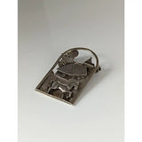 Silver brooch with a detailed silver steed farm relief of horse house and church under an arched frame
