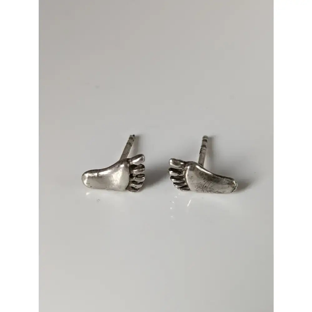 Silver steed silver feet stud earrings with detailed toe impressions and polished metallic finish
