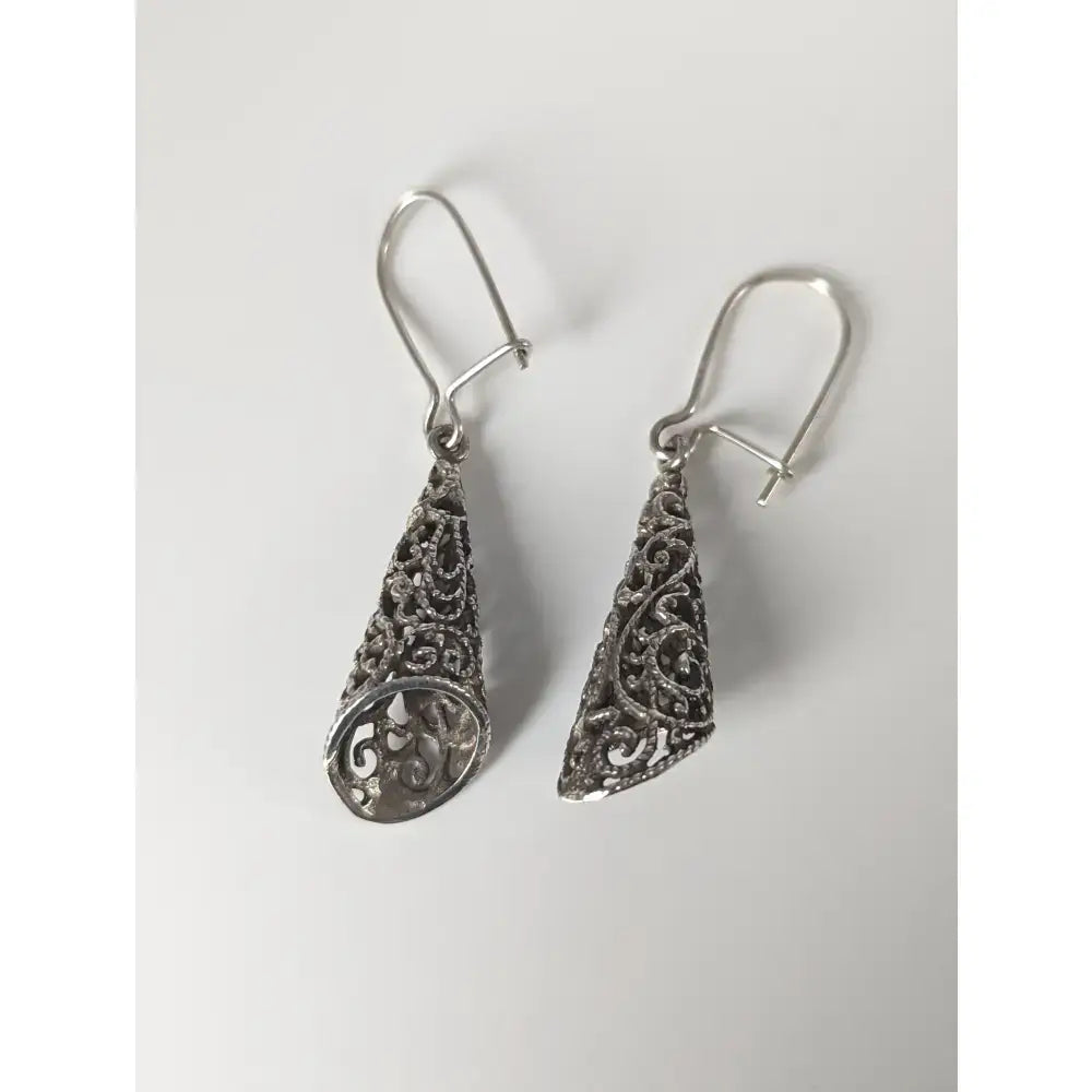 Silver steed filigree cone dropped earrings with intricate swirling patterns in handmade silver teardrop design