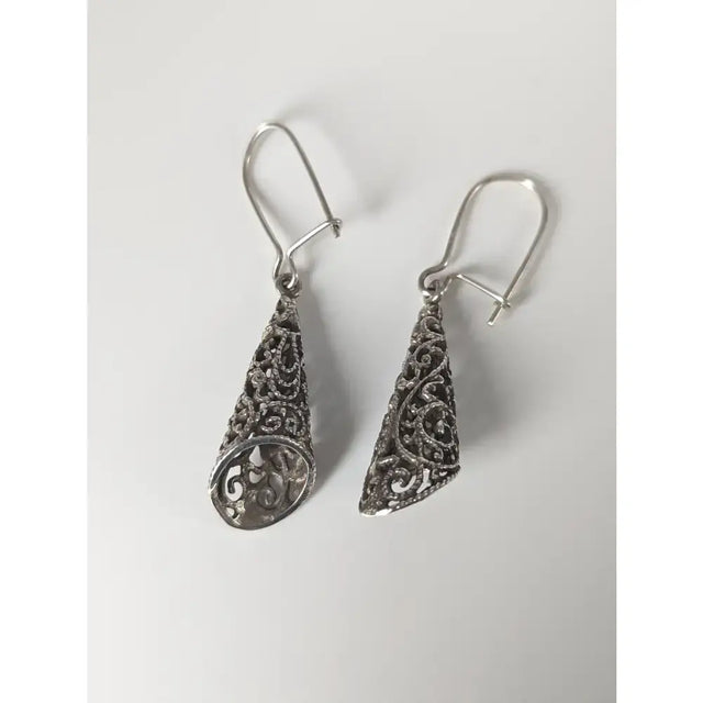 Silver steed filigree cone dropped earrings with intricate swirling patterns in handmade silver teardrop design