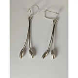 Silver steed flower stem dangling earrings with sleek silver drop design and oval-shaped bead tips