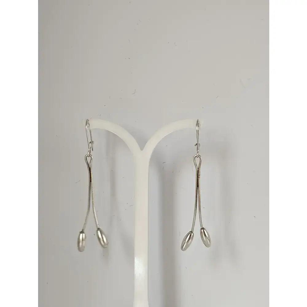 Silver steed flower stem dangling earrings with sleek silver drop design and elongated teardrop pendants