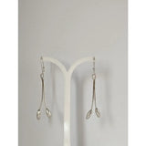 Silver steed flower stem dangling earrings with sleek silver drop design and elongated teardrop pendants
