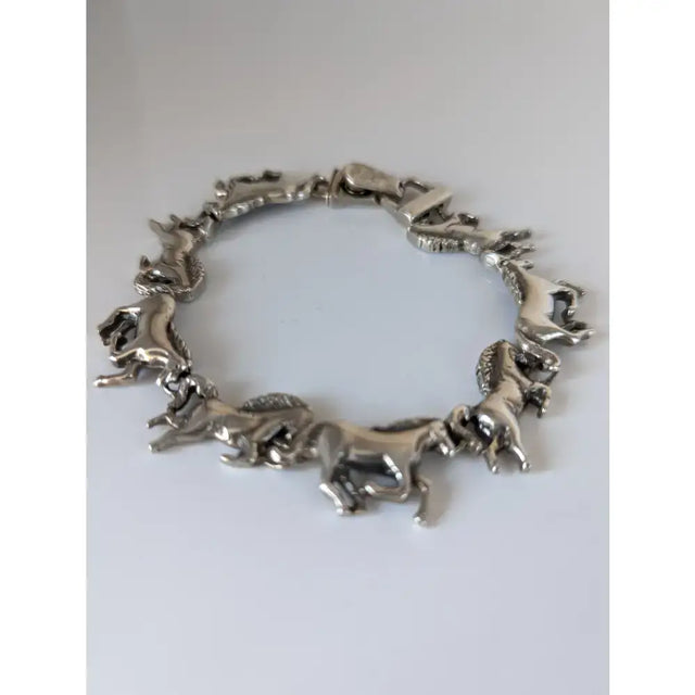 Silver steed silver galloping horses bracelet featuring a silver-toned horses bracelet with intricate horse figures linked in a circle