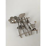 Silver steed garden silver brooch with a flower, clear gemstone center, leaves, and miniature watering can on metal frame