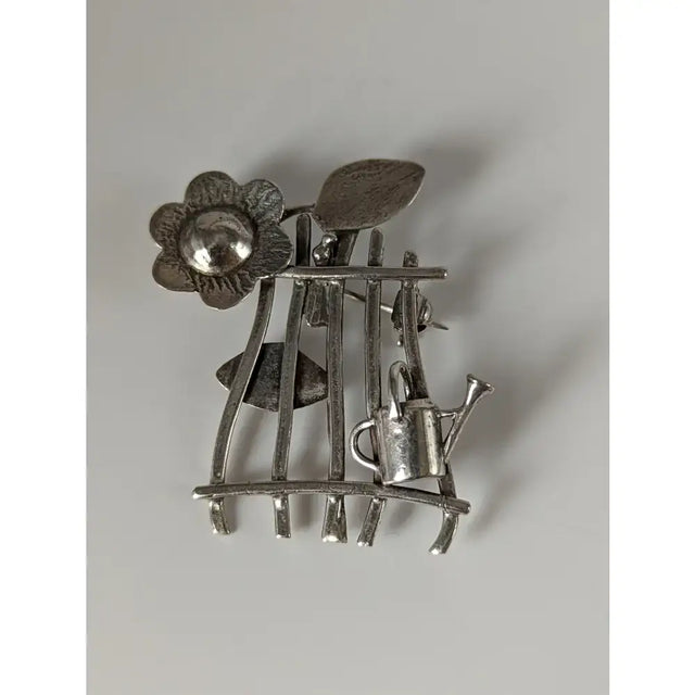 Silver steed garden silver brooch featuring a metal flower leaf and watering can perfect for horse lovers