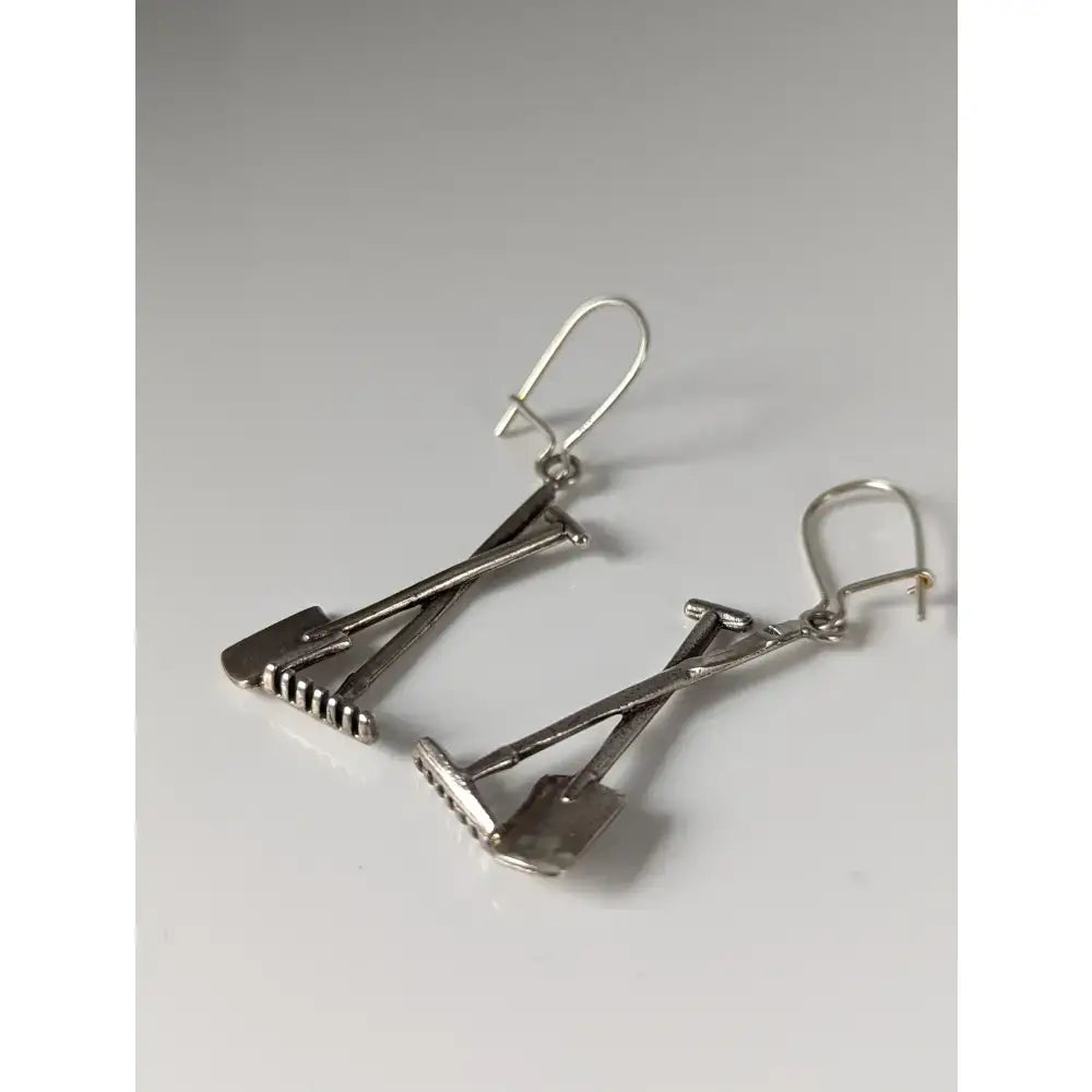 Silver steed gardening tools dropped earrings in silver shaped like crossed shovels with detailed tines and handles