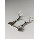 Silver steed gardening tools dropped earrings in silver shaped like crossed shovels with detailed tines and handles